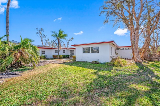 5412 Pali Way, St Pete Beach, FL 33706 - back of property featuring stucco siding and a lawn