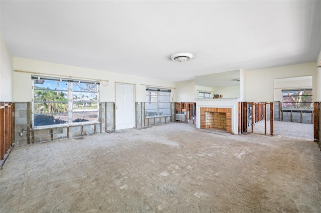 unfurnished living room featuring a brick fireplace