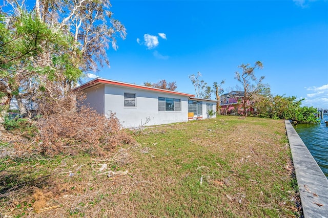 exterior space featuring a yard and a water view