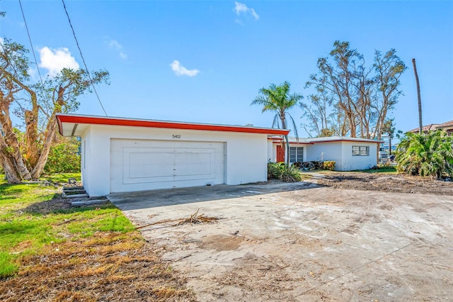 single story home featuring a garage