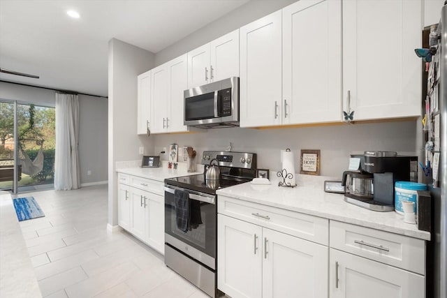 8607 Canyon Creek Trl, Parrish, FL 34219 - kitchen featuring stainless steel appliances, white cabinets, light stone countertops, and recessed lighting