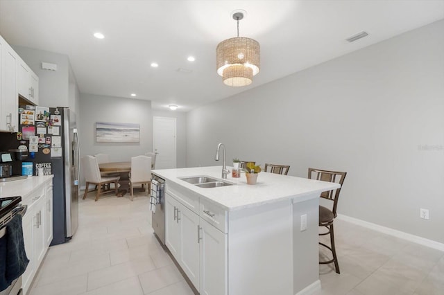 8607 Canyon Creek Trl, Parrish, FL 34219 - kitchen with a breakfast bar area, stove, white cabinetry, an island with sink, and light countertops