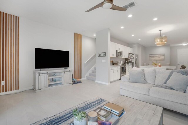 8607 Canyon Creek Trl, Parrish, FL 34219 - living room with a ceiling fan, stairs, and recessed lighting