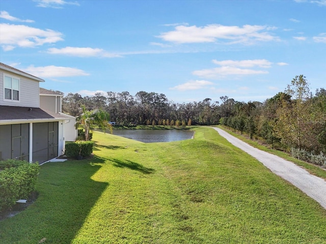 view of yard with a water view and a sunroom