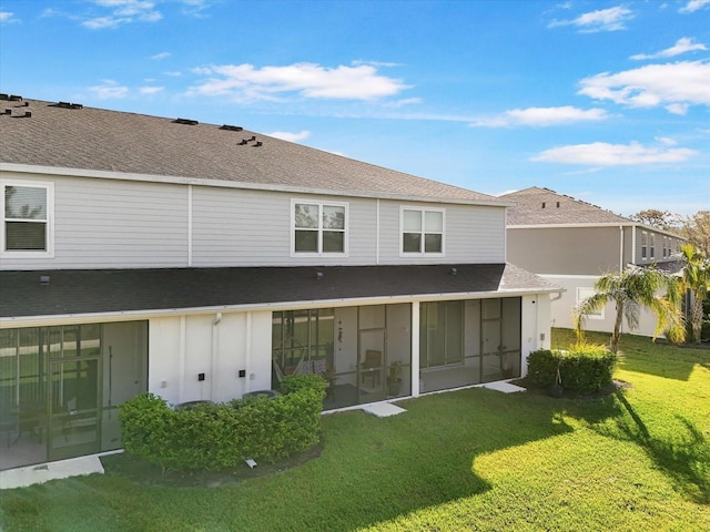 8607 Canyon Creek Trl, Parrish, FL 34219 - back of property with a shingled roof, board and batten siding, a yard, and a sunroom