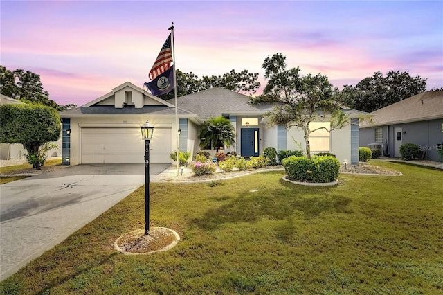 view of front of home featuring a yard and a garage