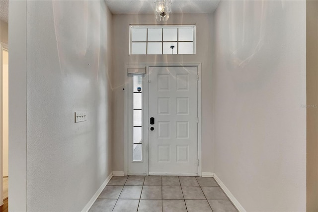 tiled foyer featuring a textured ceiling