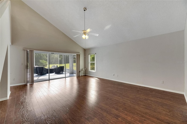 unfurnished living room with dark wood-type flooring, a textured ceiling, high vaulted ceiling, and ceiling fan