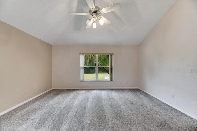 carpeted spare room featuring a textured ceiling, ceiling fan, and vaulted ceiling