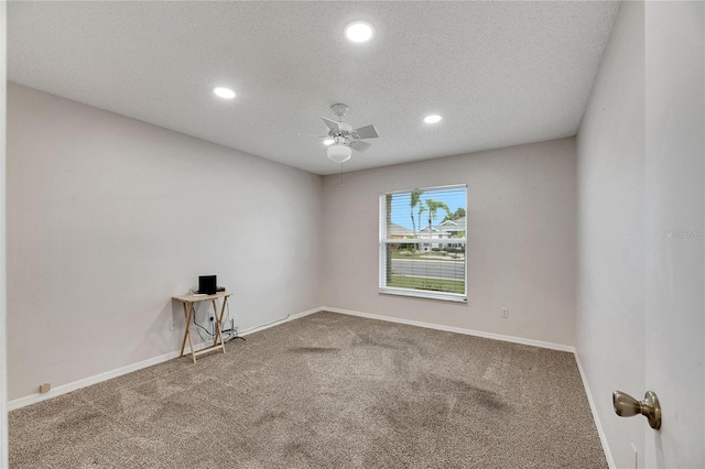 empty room featuring a textured ceiling, carpet, and ceiling fan