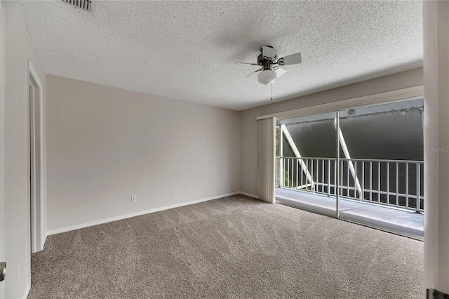 carpeted empty room with a textured ceiling and ceiling fan