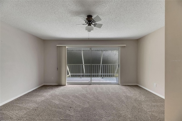 carpeted spare room with ceiling fan and a textured ceiling