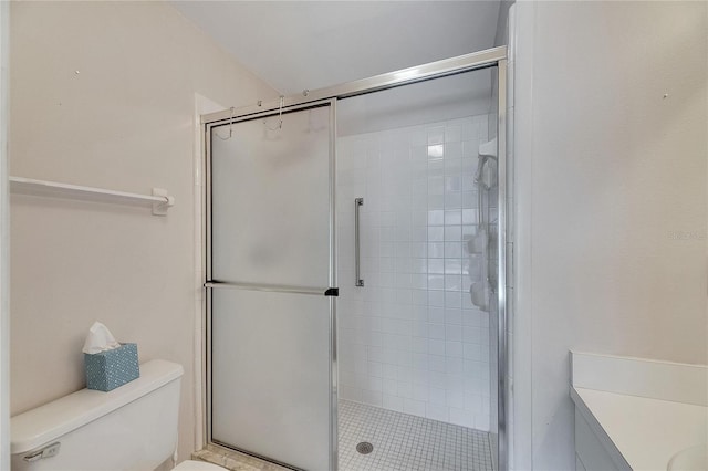 bathroom featuring a shower with door, vanity, and toilet