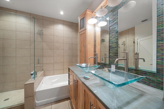 bathroom featuring tile patterned floors, separate shower and tub, tile walls, and vanity