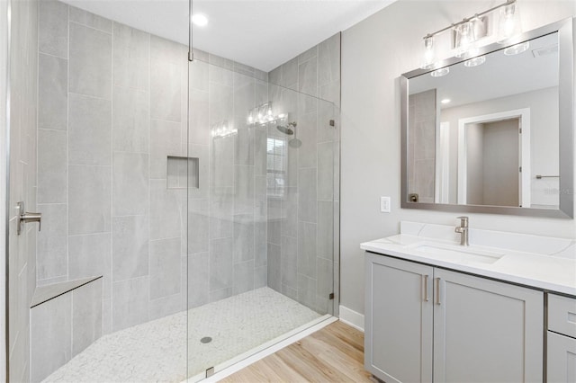 bathroom featuring vanity, wood-type flooring, and an enclosed shower