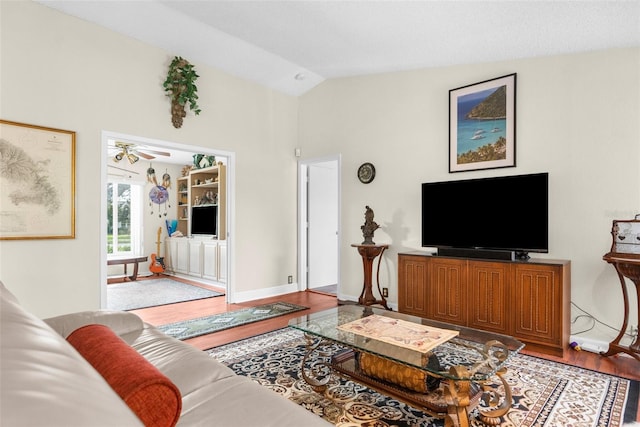 living room featuring wood-type flooring, vaulted ceiling, and ceiling fan