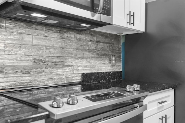 kitchen with stainless steel appliances, white cabinetry, and decorative backsplash