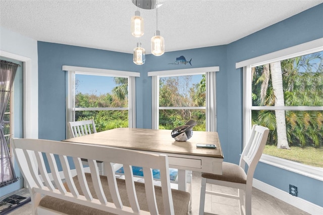 dining space featuring a textured ceiling