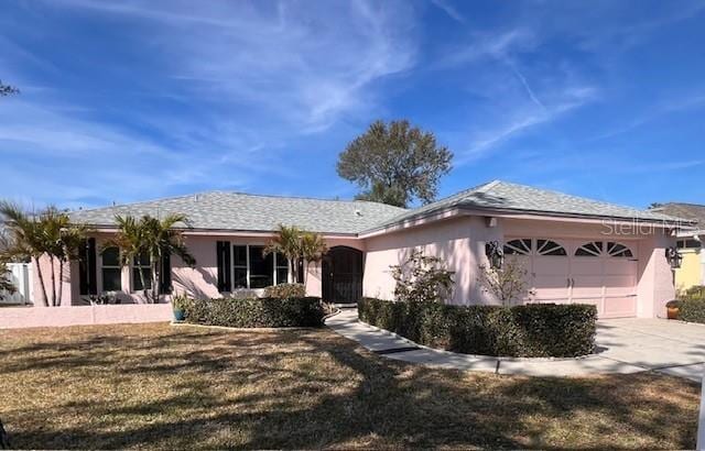 single story home with a garage and a front yard