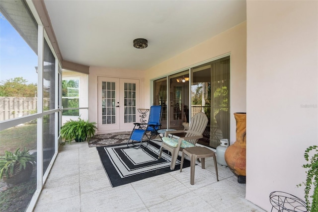 sunroom / solarium featuring french doors