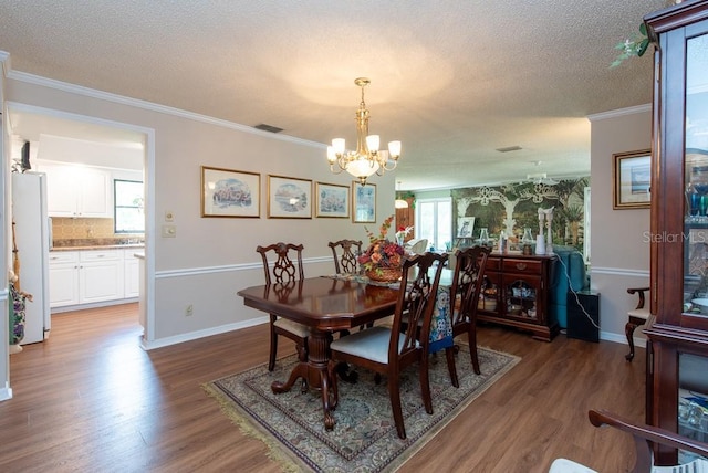 dining area featuring ornamental molding, dark wood-type flooring, and plenty of natural light