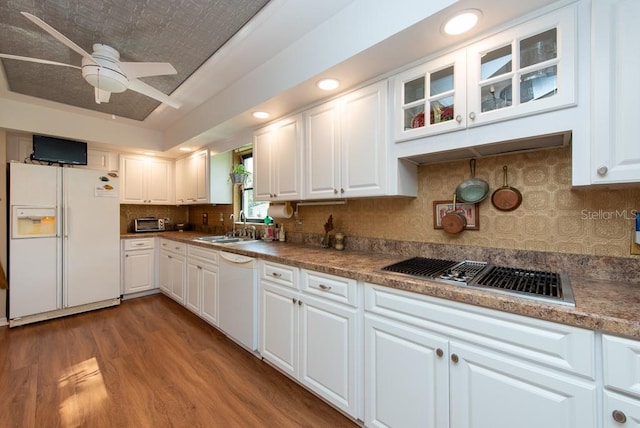 kitchen with sink, white cabinets, hardwood / wood-style flooring, and white appliances