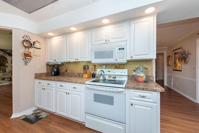 kitchen with backsplash, white cabinets, white appliances, and light hardwood / wood-style floors