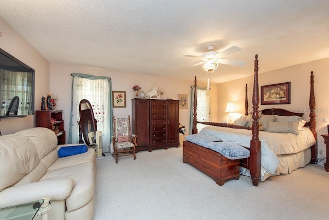 carpeted bedroom with a textured ceiling and ceiling fan