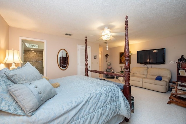 bedroom with a textured ceiling, carpet floors, and ceiling fan