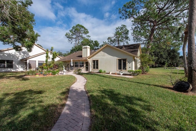 rear view of house with a yard