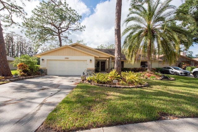 ranch-style house featuring a front lawn and a garage