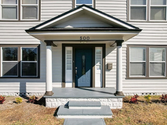 doorway to property featuring covered porch