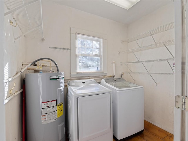 laundry area with separate washer and dryer, hardwood / wood-style flooring, and water heater