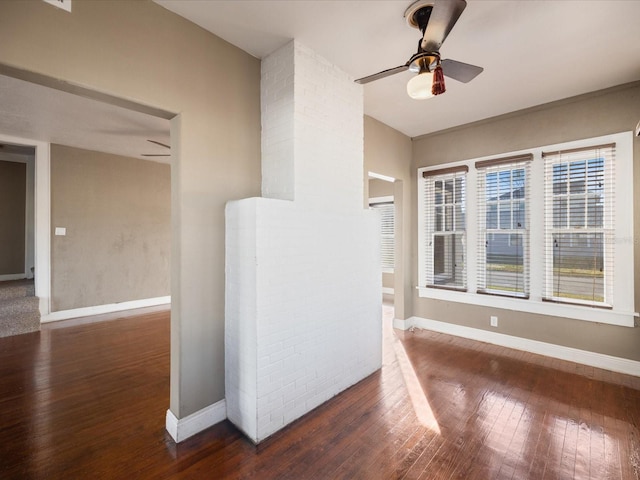 spare room featuring a ceiling fan, baseboards, and hardwood / wood-style floors