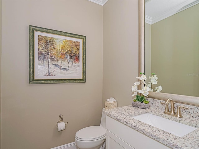 bathroom with vanity, toilet, and crown molding