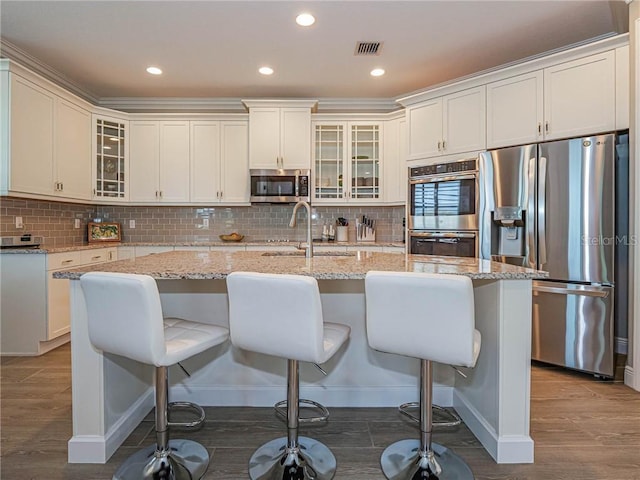 4836 Four Lakes Cir SW, Vero Beach, FL 32968 - kitchen featuring a sink, visible vents, wood finished floors, and stainless steel appliances