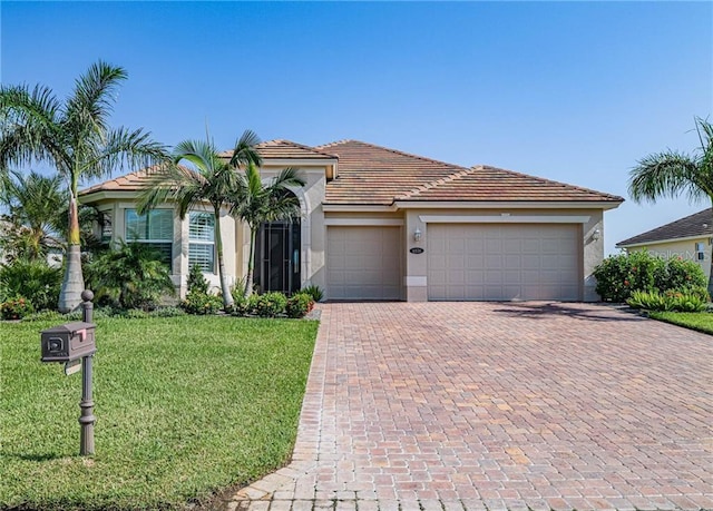 4836 Four Lakes Cir SW, Vero Beach, FL 32968 - mediterranean / spanish home with stucco siding, decorative driveway, a front yard, a garage, and a tiled roof