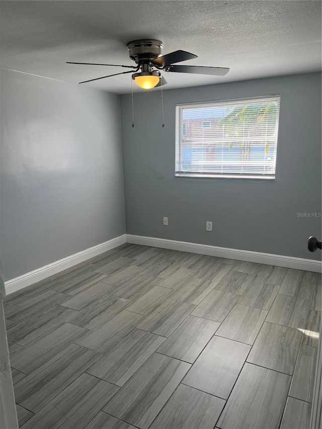 unfurnished room with light hardwood / wood-style floors, a textured ceiling, and ceiling fan