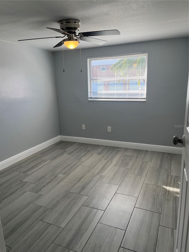 unfurnished room with a textured ceiling, light hardwood / wood-style floors, and ceiling fan