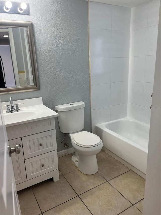 full bathroom featuring toilet, tiled shower / bath, vanity, and tile patterned flooring