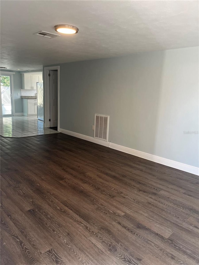 unfurnished room featuring dark hardwood / wood-style flooring