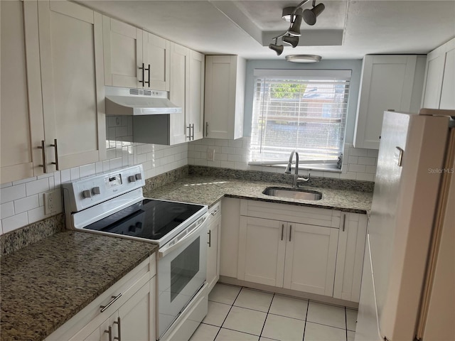 kitchen featuring white appliances, a tray ceiling, white cabinetry, and sink