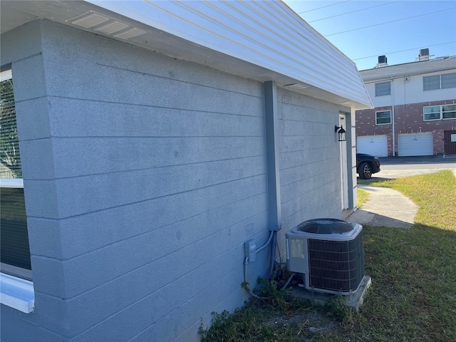 view of side of home with central AC unit