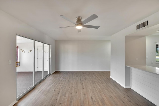 unfurnished room featuring hardwood / wood-style flooring and ceiling fan