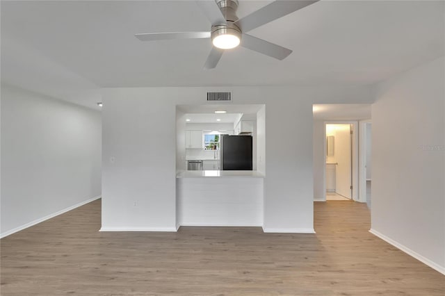 unfurnished living room featuring light hardwood / wood-style flooring and ceiling fan