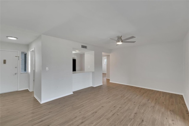 unfurnished living room featuring light hardwood / wood-style flooring and ceiling fan