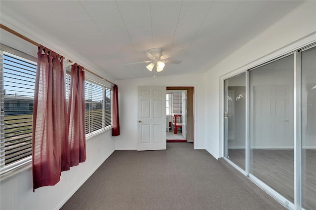 unfurnished sunroom with vaulted ceiling and ceiling fan