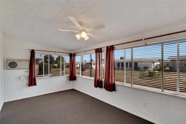 unfurnished sunroom featuring ceiling fan and a healthy amount of sunlight