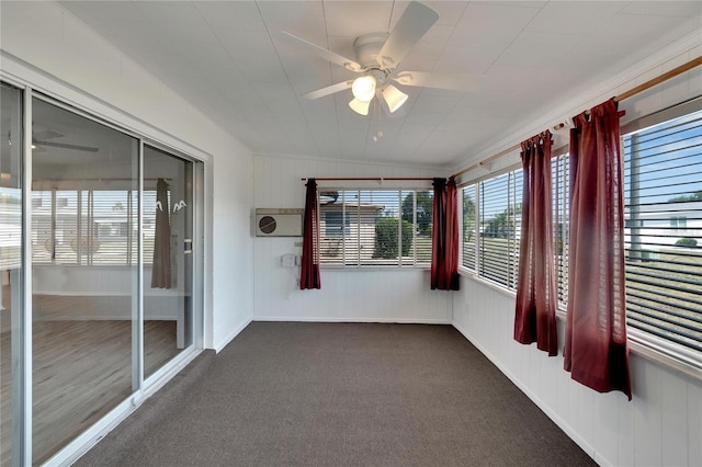 unfurnished sunroom with ceiling fan, plenty of natural light, and vaulted ceiling