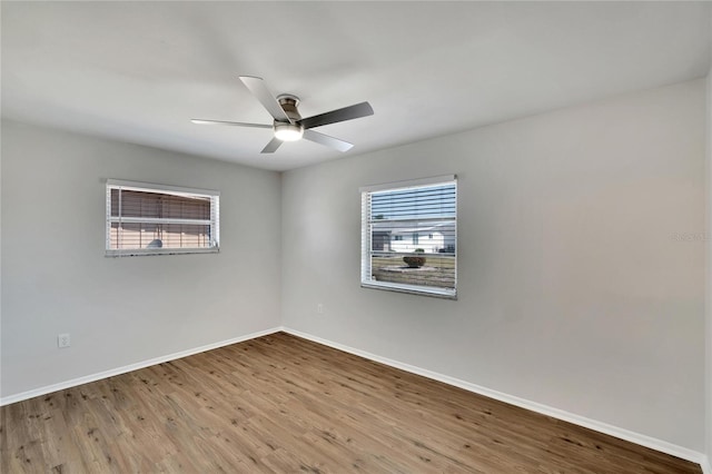 unfurnished room with a wealth of natural light, light hardwood / wood-style floors, and ceiling fan